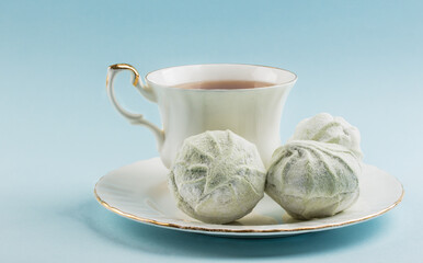 A cup of tea and bean on a neutral background