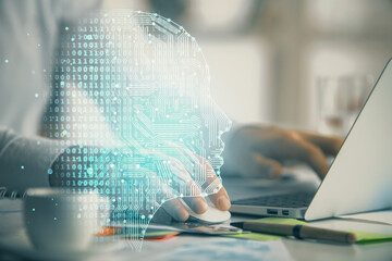 Man typing on keyboard background with brain hologram. Concept of big Data.