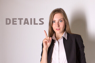 Businesswoman in a suit with finger points to the world delails
