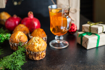 christmas sweet dessert muffins cupcakes and cup of tea party festive table setting holidays new year gift tasty top view copy space food background rustic