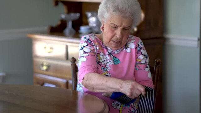 POV Concept Of Elderly Caucasian Woman Engaged In A Video Conference With Her Doctor Via A Telehealth Or Doctor On Demand App On Her Wireless Mobile Device.