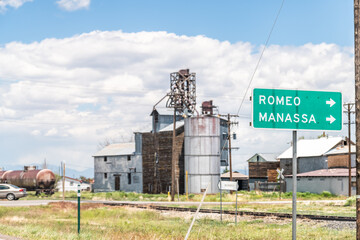 Romeo, USA - June 20, 2019: Highway 285 in Colorado with old vintage town industrial building and...