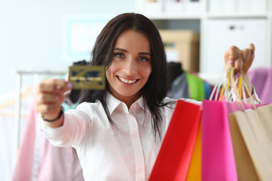 Happy Girl At Home Shows Credit Card And Packages. Make Purchases With Credit Card During Self-isolation. Modern Virtual Shopping. Help From An Independent Stylist. Images Are Composed