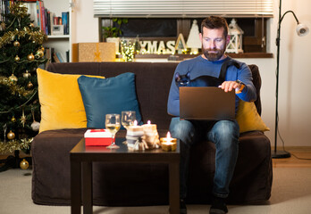 man with cat celebrating Christmas at home social distancing