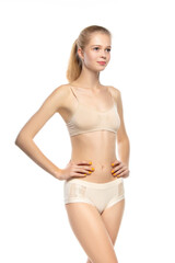 Fototapeta premium Healthful. Beautiful female model on white background. Beauty, cosmetics, spa, depilation, diet and treatment, fitness concept. Fit and sportive, sensual body with well-kept skin in underwear.
