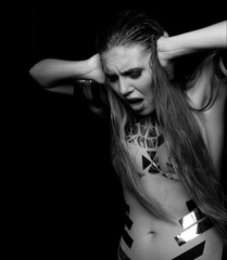 Woman dressed with adhesive tape on body scotch  in dark atmosphere