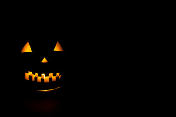 Helloween symbol with mad face, glowing eyes, mouth and teeth.