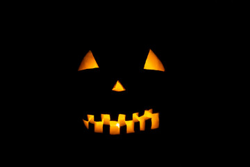 Helloween symbol with mad face, glowing eyes, mouth and teeth.