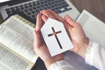Woman praying by faith with computer laptop, Church services online concept, Online church at home...