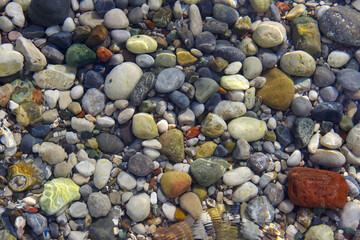 Marine multicolored pebbles in the mediterranean sea.