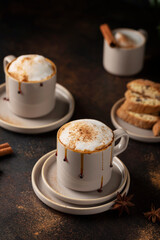 Hot winter cappuccino with cinnamon and caramel