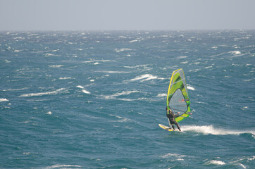 Windsurfer sailing in the coast of Arinaga. Aguimes. Gran Canaria. Canary Islands. Spain.