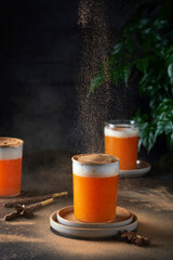 Winter ornage drink with milk, cinnamon and pumking