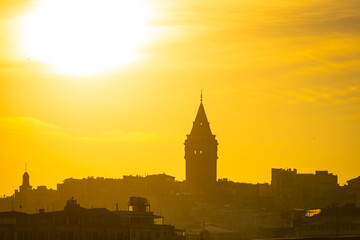 Galata Tower at sunset. Sun over the Galata Tower. Cityscape of Istanbul with Galata Tower at sunset. 