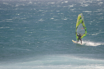 Windsurfer sailing in the coast of Arinaga. Aguimes. Gran Canaria. Canary Islands. Spain.