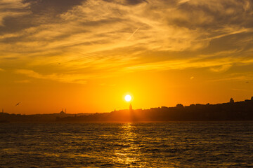 Galata Tower at sunset. Sun over the Galata Tower. Cityscape of Istanbul with Galata Tower at sunset. 
