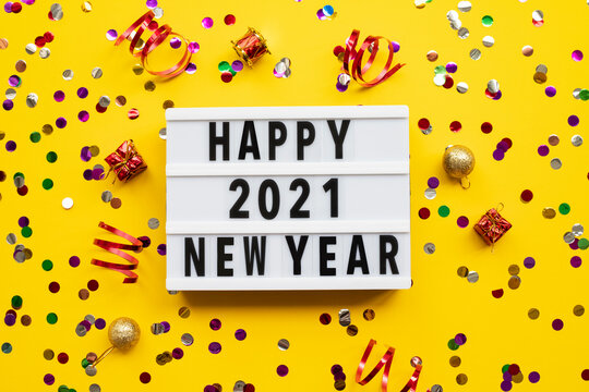 Lightbox with text HAPPY NEW YEAR 2021 on yellow background. Top view. New year celebration. Happy New Year 2021 concepts - Image
