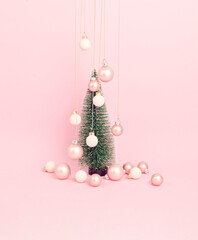 Christmas tree with ornaments over pink background. Minimal picture for winter holidays