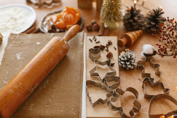 Making gingerbread cookies, Christmas holiday tradition. Raw gingerbread dough and metal cutters