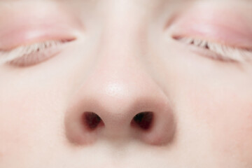 Nose and eyelid. Close up portrait of beautiful albino female model. Parts of face and body....