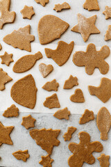 Cooking gingerbread cookies. Raw gingerbread cookies in festive christmas shapes on oven tray