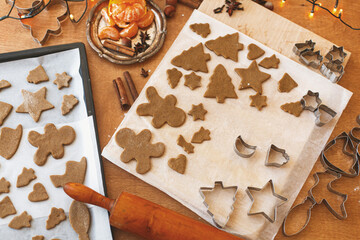 Making gingerbread cookies, Christmas tradition. Raw gingerbread dough with festive metal cutters