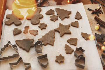 Cooking gingerbread cookies, Christmas holiday advent. Raw gingerbread cookies and metal cutters