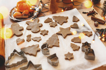 Making gingerbread cookies, Christmas holiday tradition. Raw gingerbread dough with metal cutters
