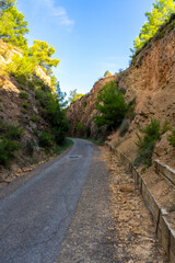 Fototapeta na wymiar View of a rural path that runs through mountain landscapes in the mountain town of Algimia de Alfara in Spain