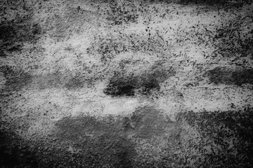 Blurred stone wall texture and background with film grain.	