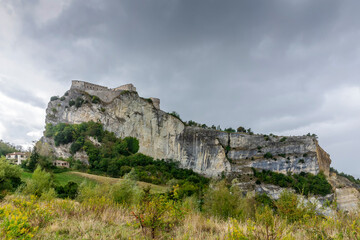 Fototapeta na wymiar The imposing fortress of San Leo, Emilia Romagna, Italy, under a stormy sky with rain clouds