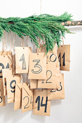 Handmade advent calendar. Gift bags hanging on the rope. Eco friendly Christma