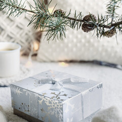 cozy winter composition with a cup, gift box,  sweater, SPOKES AND BALL on a light festive background