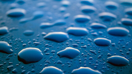 Water drops on dark surface. Abstract background.  Natural pattern close up photo. 
