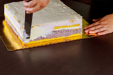 Chef cover with icing festive cake. Making layer sponge cake.