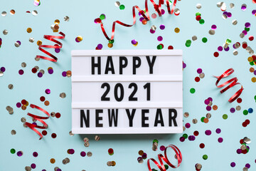 Lightbox with text HAPPY NEW YEAR 2021 on blue background. Top view. New year celebration. Happy New Year 2021 concepts - Image