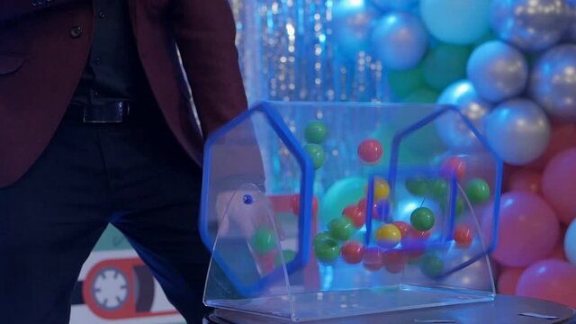 Plastic balls are mixed in a bingo drum. the drawing of prizes using a Lotto.