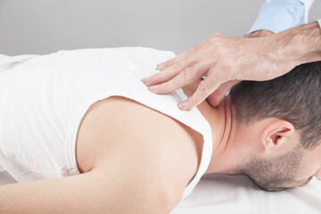 Fototapeta na wymiar Caucasian doctor massaging neck of man.