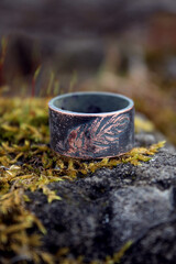 copper ring with the image of bird feathers