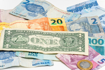 Fototapeta na wymiar one dollar bill on Brazilian money notes, devaluation of Brazilian money
