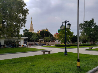 A temple and a bench with lights in a park in cambodia phnom penh