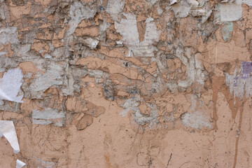 warm beige texture of torn off old street wall ads