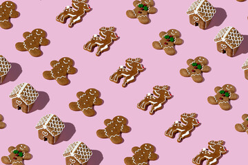 Creative Christmas pattern layout made with gingerbread man on pastel pink background. Minimal winter or New Year concept. Template for greeting card or design with copy space. Flat lay.