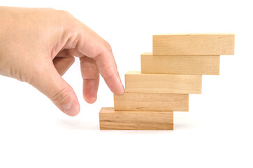 Hands of a business man climbing a toy wooden ladder. Career growth concept.