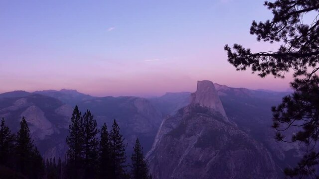 Magenta alpen glow after sunset on Half Dome and High Sierra Nevada Mountains from Washburn Point, Yosemite NP.