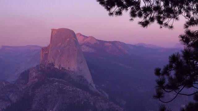 Magenta alpen glow after sunset on Half Dome and High Sierra Nevada Mountains from Washburn Point, Yosemite NP.