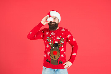Fototapeta na wymiar Dear santa. merry christmas. cheerful bearded man in santa hat and sweater. brutal hipster celebrate xmas party. winter holiday preparations. male winter knitwear fashion. happy new year
