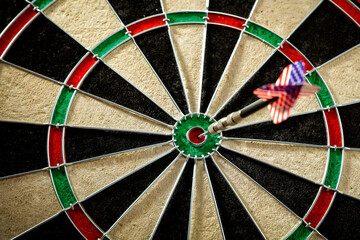 A dartboard with a vibrating dart of the USA flag on a beautiful evening