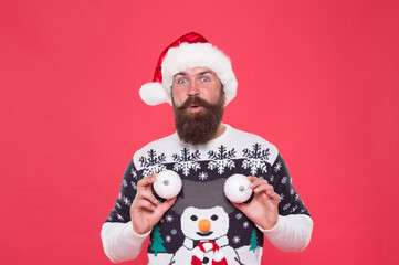 Jingle bells. new year tree decoration. happy bearded man in santa hat. new year party fun. celebrate winter holidays. merry christmas. man in sweater hold decorative snowballs. xmas shopping time