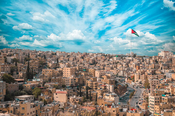 Scenic shot of the city of Amman with the Jordan flag in Jordan